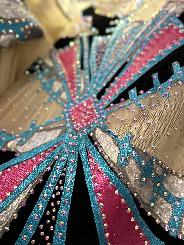 Big Apple Circus Hometown Playground costume detail: teal and pink starburst bands set with rhinestones on black velvet. Costume design by Cynthia Nordstrom