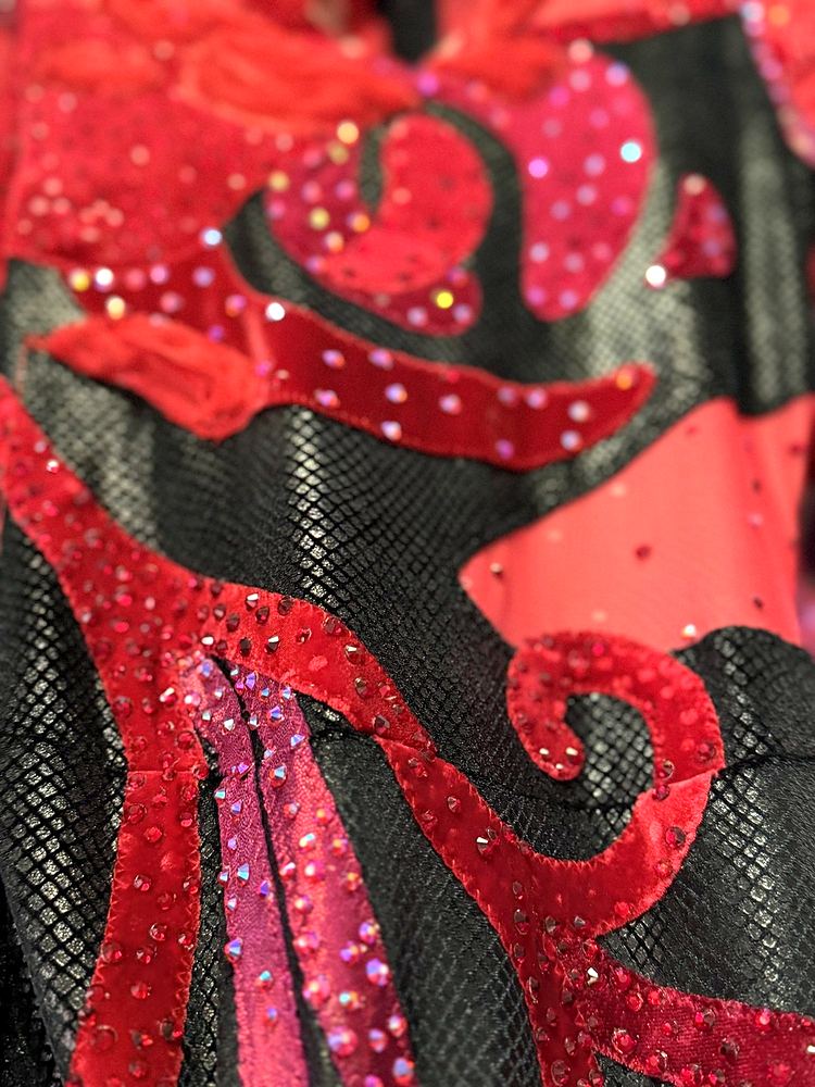 Big Apple Circus Hometown Playground costume detail: a red velvet scroll appliqué and crystals on textured black fabric. Costume design by Cynthia Nordstrom