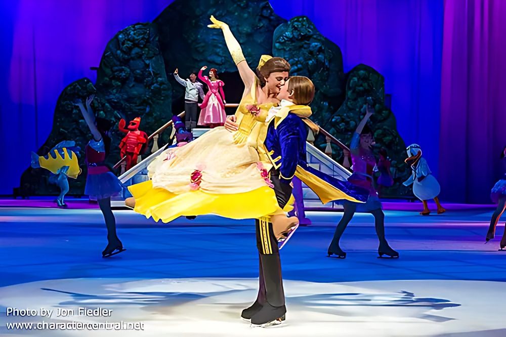 Belle in a yellow ball gown lifted by the Prince before a rose garden set, Rockin' Ever After. Costume design by Cynthia Nordstrom