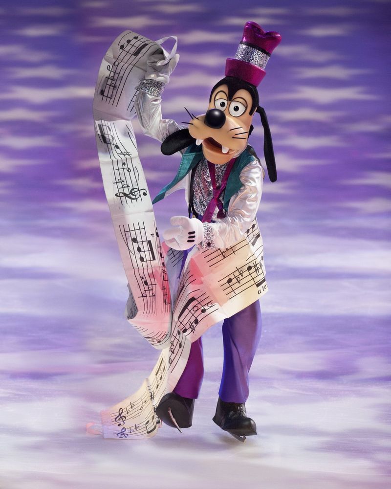 Goofy in a purple vest and hat skating with a long sheet of music, Rockin' Ever After. Costume design by Cynthia Nordstrom
