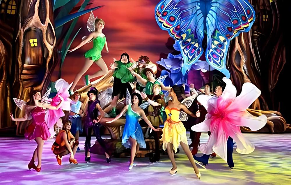 Fairies in bright petal costumes and wings in a garden set finale, Disney On Ice: Worlds of Fantasy. Costume design by Cynthia Nordstrom