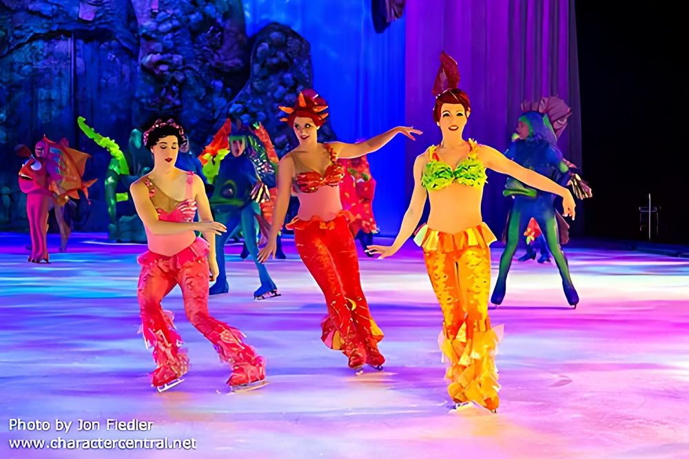 Mermaid skaters in red and gold shell tops and flowing pants, Disney On Ice: Worlds of Fantasy. Costume design by Cynthia Nordstrom