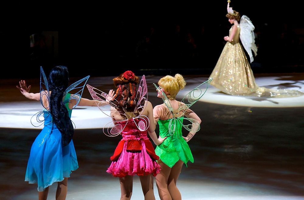 Fairies in blue, pink and green before Queen Clarion in a gold gown, Disney On Ice: Worlds of Fantasy. Costume design by Cynthia Nordstrom