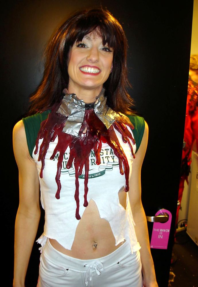 Actress backstage in a torn white T-shirt with a stage-blood neck wound, Evil Dead: The Musical. Costume design by Cynthia Nordstrom