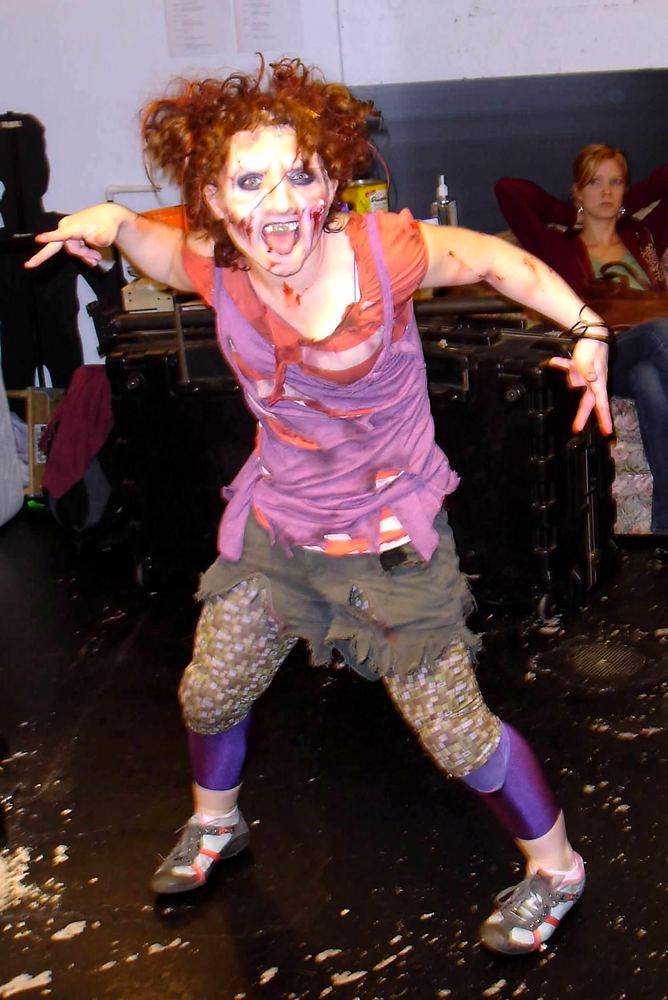 Evil Dead: The Musical: Cheryl as a Deadite in her purple top, camo shorts and torn leggings. Costume design by Cynthia Nordstrom