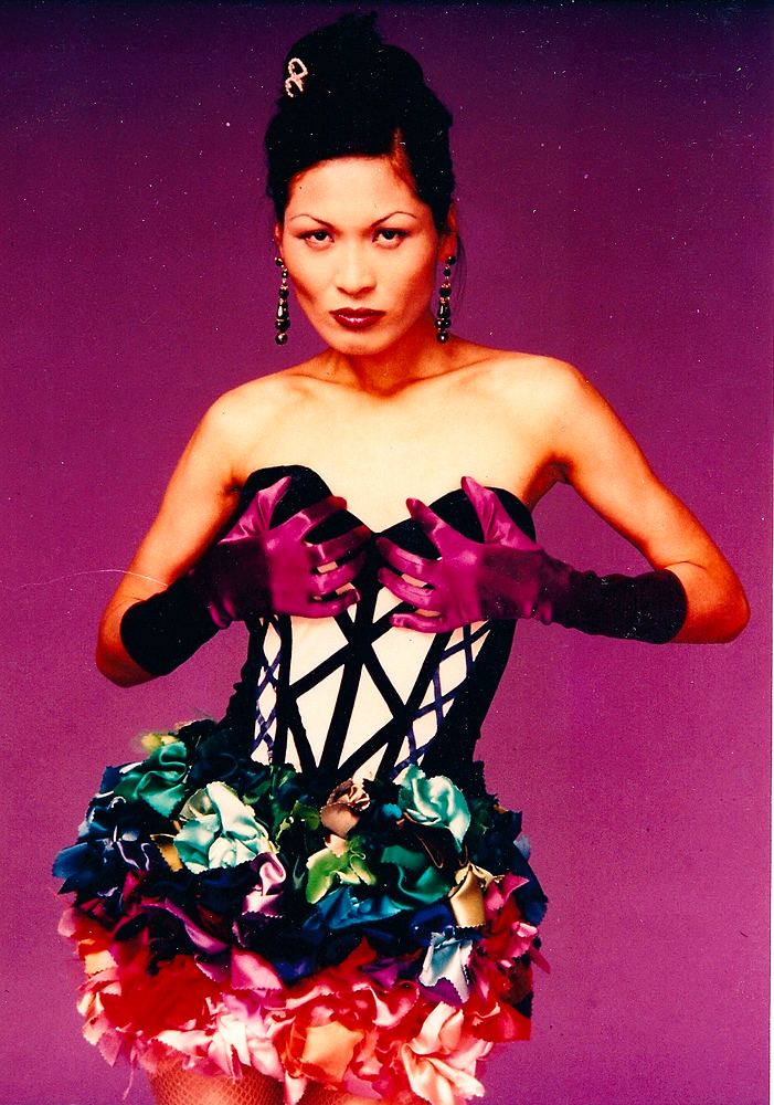 Model in a black strapped corset bodice with a ruffled jewel-tone skirt, Fashion & Art. Costume design by Cynthia Nordstrom