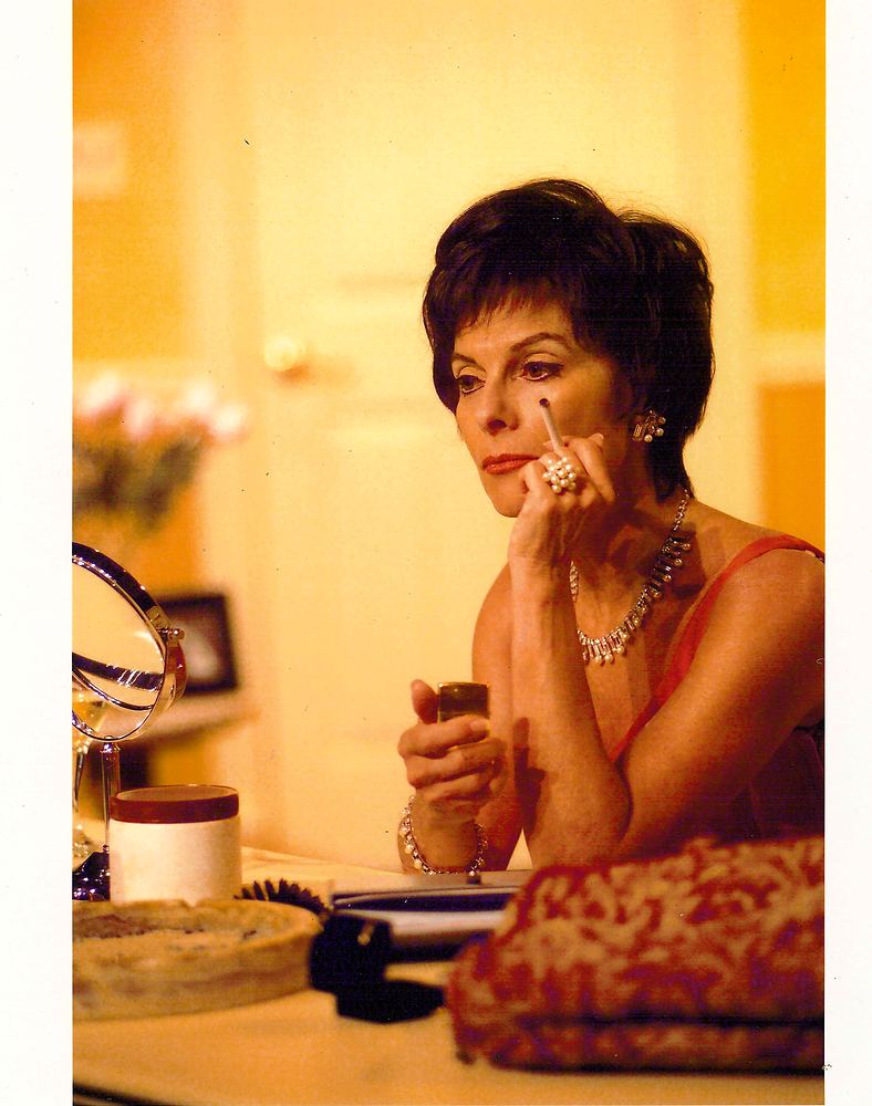Judy Garland at a dressing table in a red slip with jewelry, This Property Known As Garland. Costume design by Cynthia Nordstrom