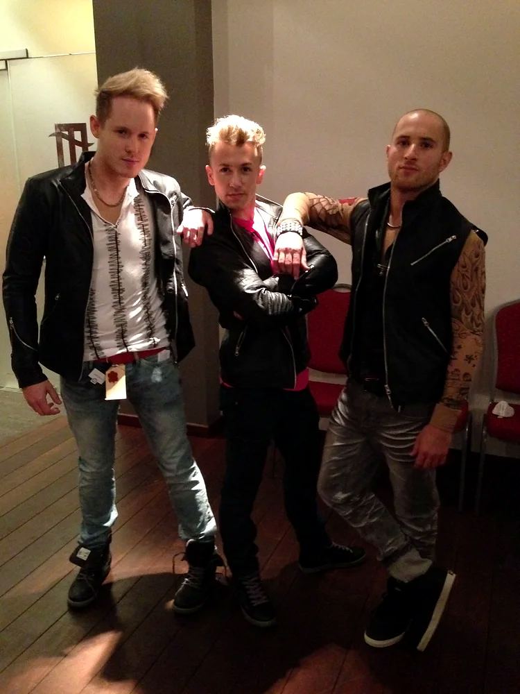 Grease: three performers in leather jackets at a fitting. Costume design by Cynthia Nordstrom