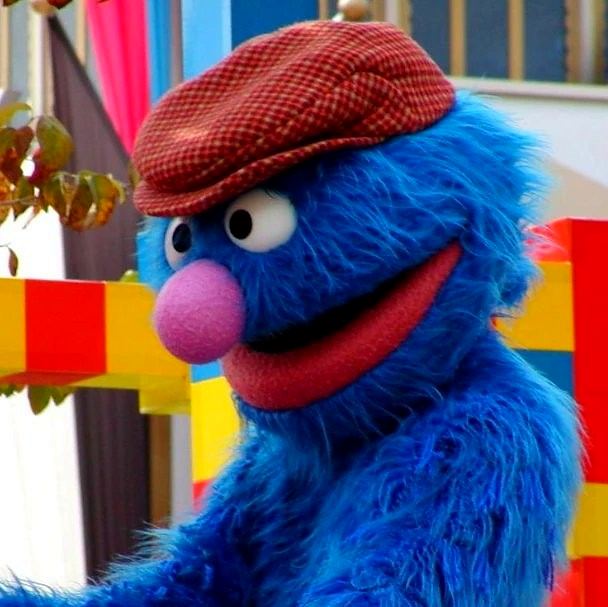 Happy Harmony Celebration: Grover in a flat cap on the parade float. Costume design by Cynthia Nordstrom