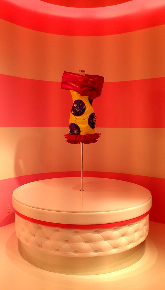Red and yellow polka dot strapless dress on a round pedestal, Hello Kitty's Wonderland, USJ. Costume design by Cynthia Nordstrom