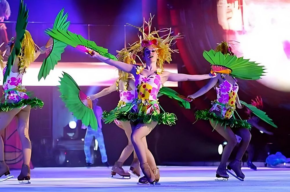 Skaters in tropical flower costumes with green feather wings, Holiday On Ice: Passion. Costume design by Cynthia Nordstrom