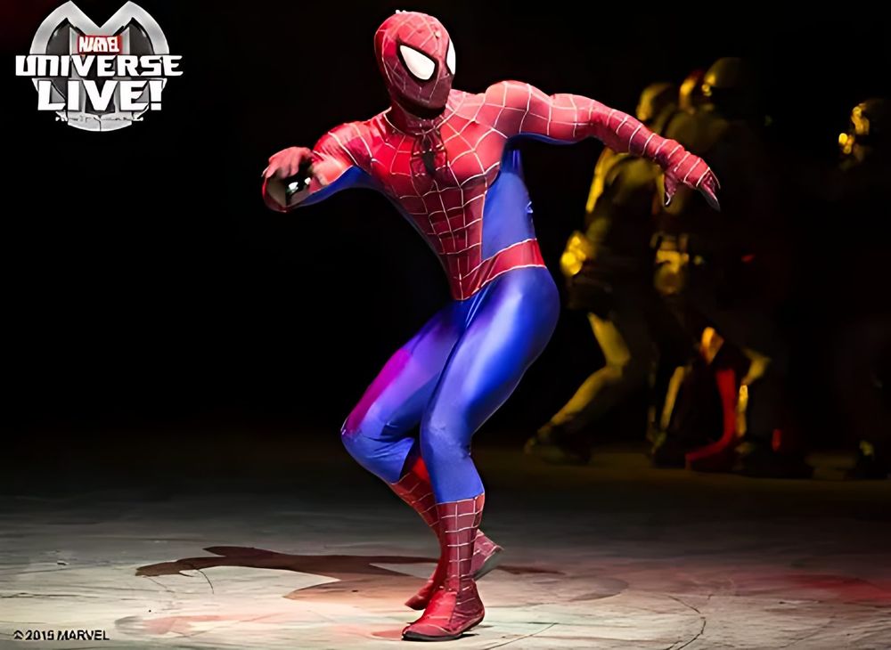 Spider-Man in a red and blue suit in a fighting stance on stage, Marvel Universe Live. Costume design by Cynthia Nordstrom