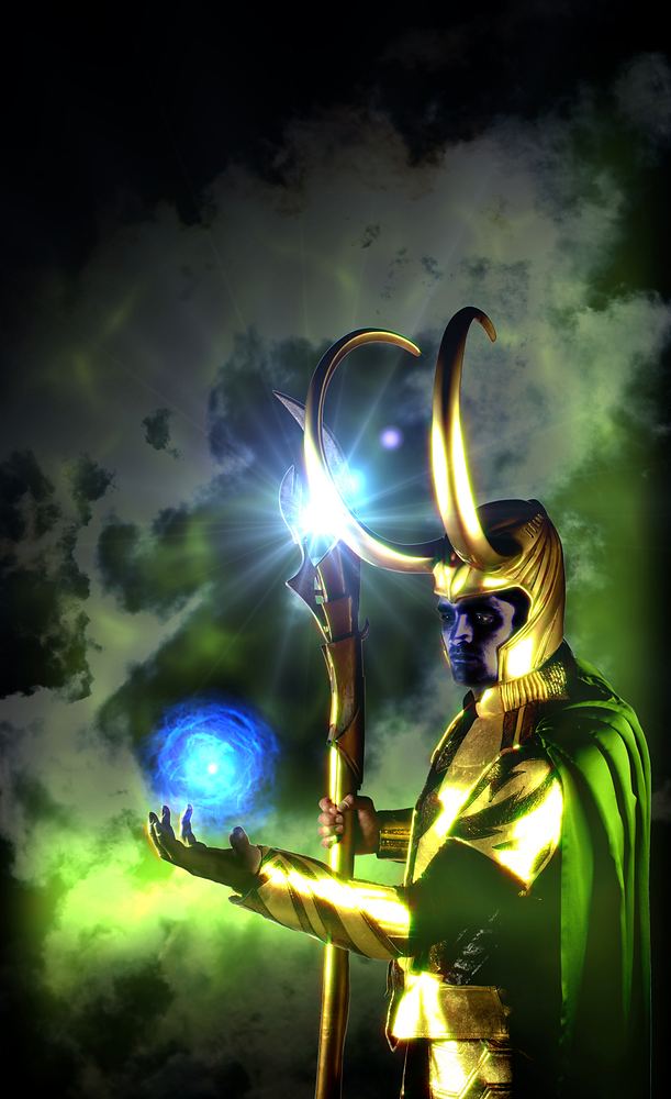 Loki in a gold horned helmet and green cape holding a glowing staff, Marvel Universe Live. Costume design by Cynthia Nordstrom
