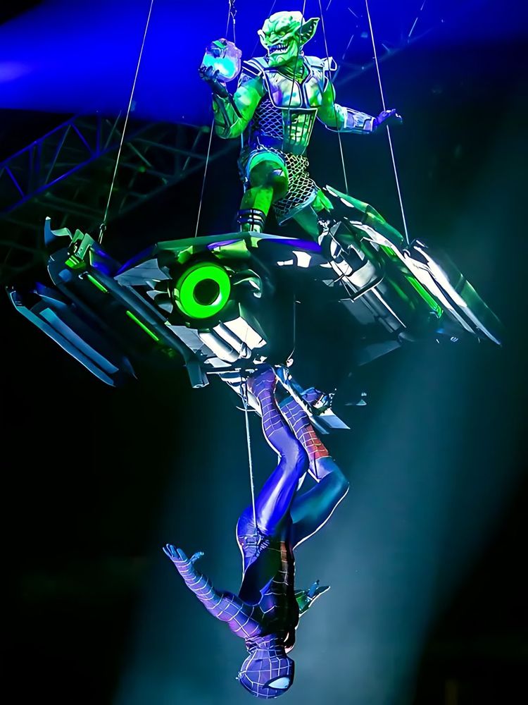 Green Goblin flying on a glider above the arena in blue light, Marvel Universe Live. Costume design by Cynthia Nordstrom