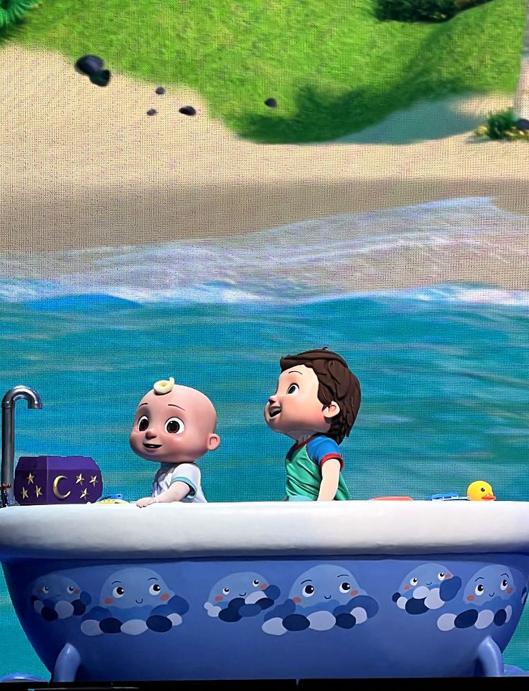 JJ and a boy character in a bathtub boat at the seaside, CoComelon Live!. Costume design by Cynthia Nordstrom