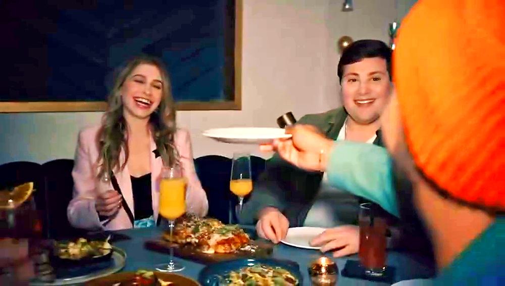 Friends in casual looks laughing over brunch at a hotel restaurant, Motto by Hilton commercial. Wardrobe design by Cynthia Nordstrom