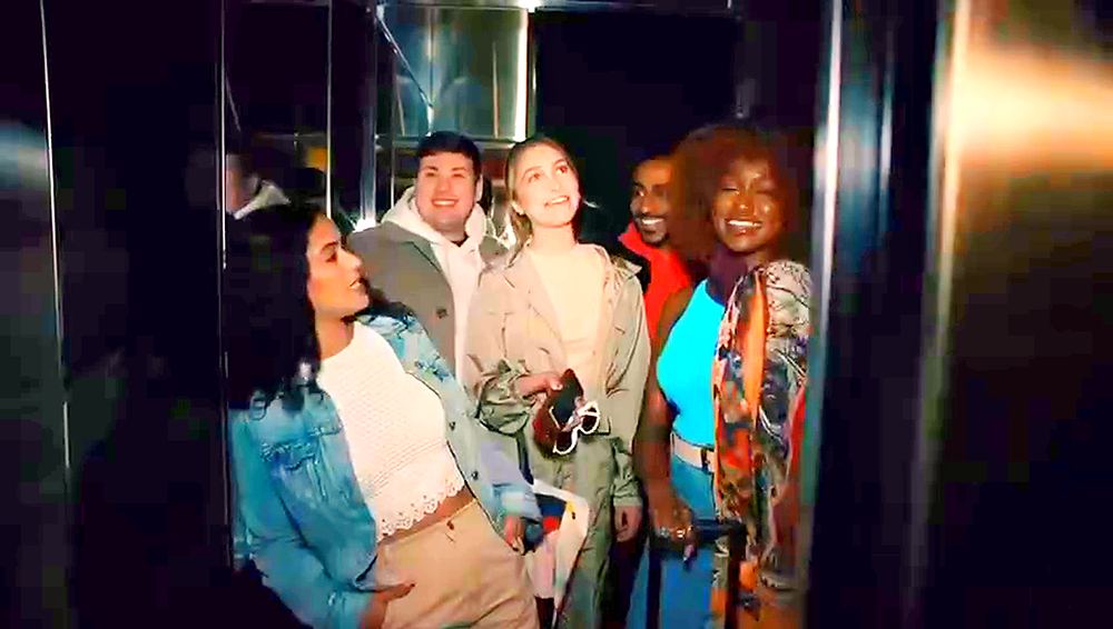 Friends in denim jacket and layered street looks in a hotel elevator, Motto by Hilton commercial. Wardrobe design by Cynthia Nordstrom