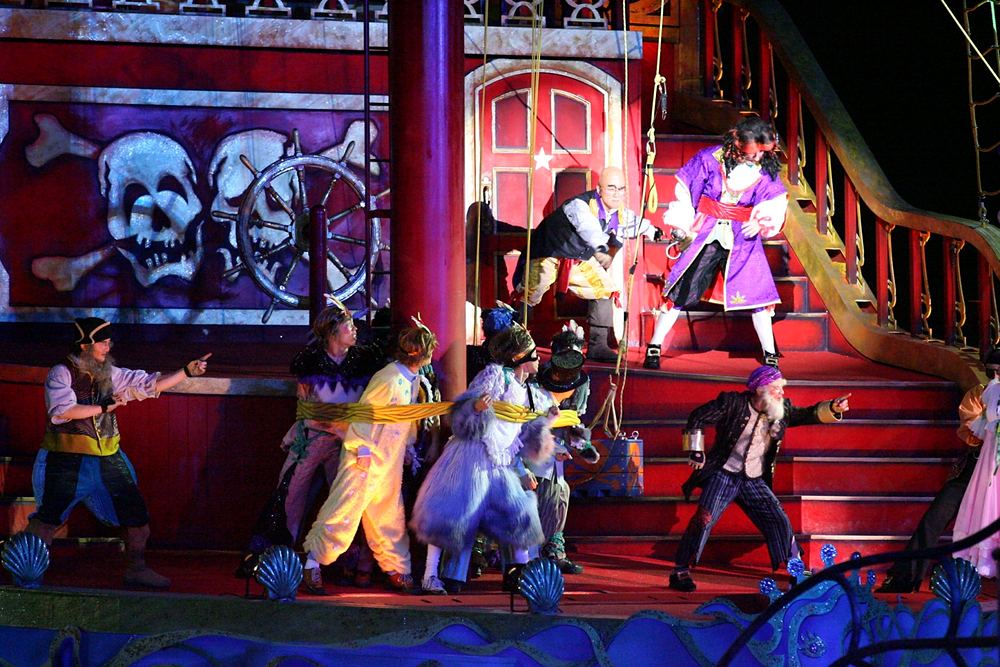 Pirate crew in striped shirts and coats on the red ship set, Peter Pan's Neverland, USJ. Costume design by Cynthia Nordstrom