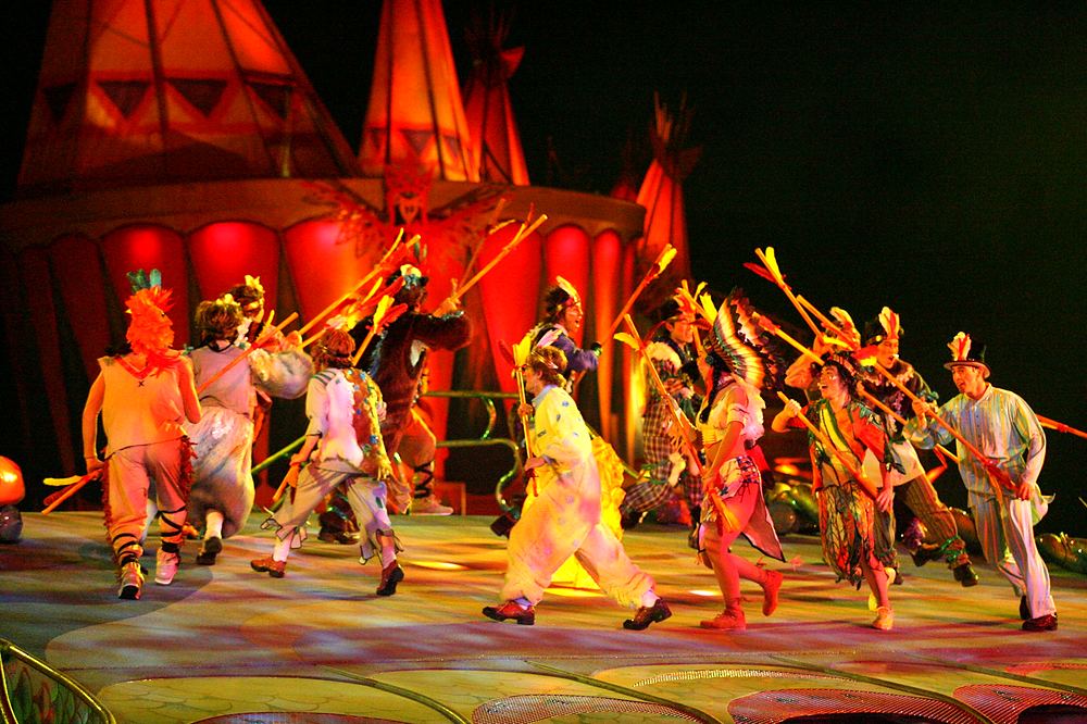 Lost Boys and tribe dancers in feathers and earth tones dancing, Peter Pan's Neverland, USJ. Costume design by Cynthia Nordstrom