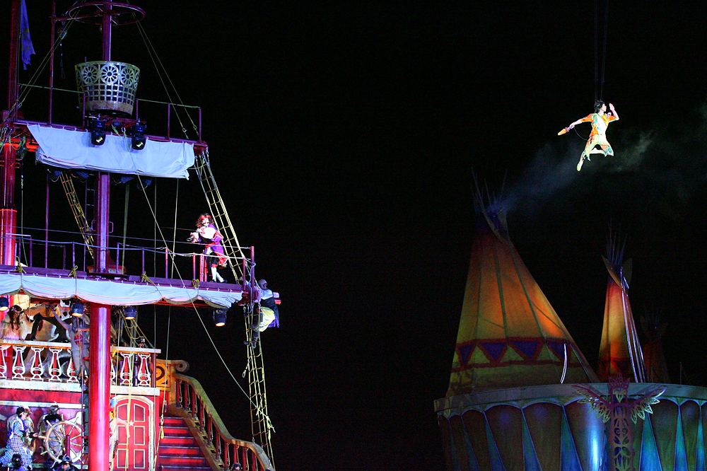 Peter Pan flying above the pirate ship and teepees, Peter Pan's Neverland, USJ. Costume design by Cynthia Nordstrom