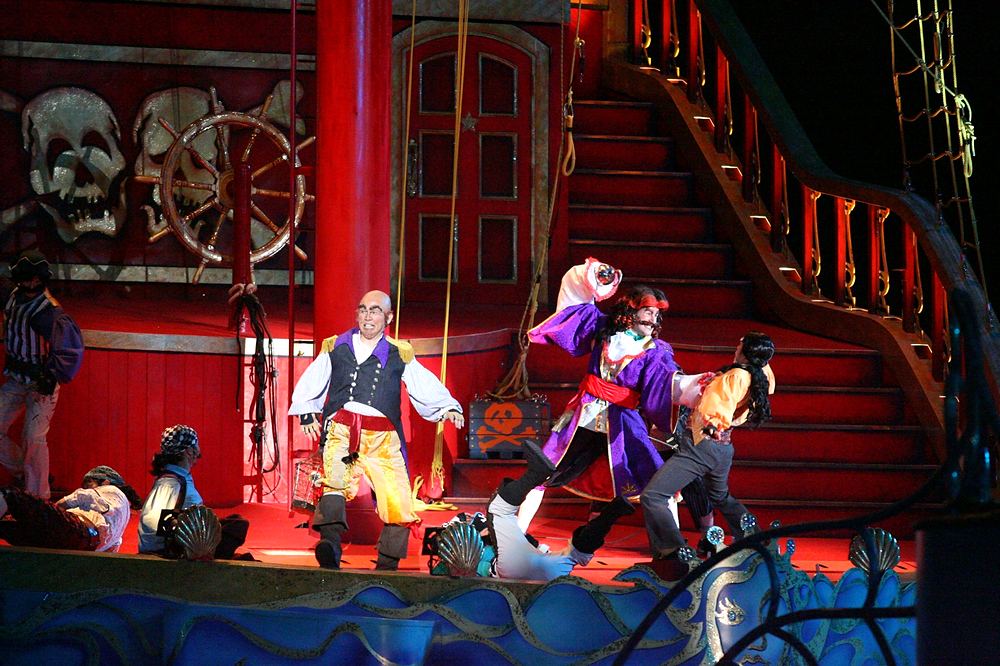 Pirates in red and purple coats fighting on the pirate ship deck, Peter Pan's Neverland, USJ. Costume design by Cynthia Nordstrom