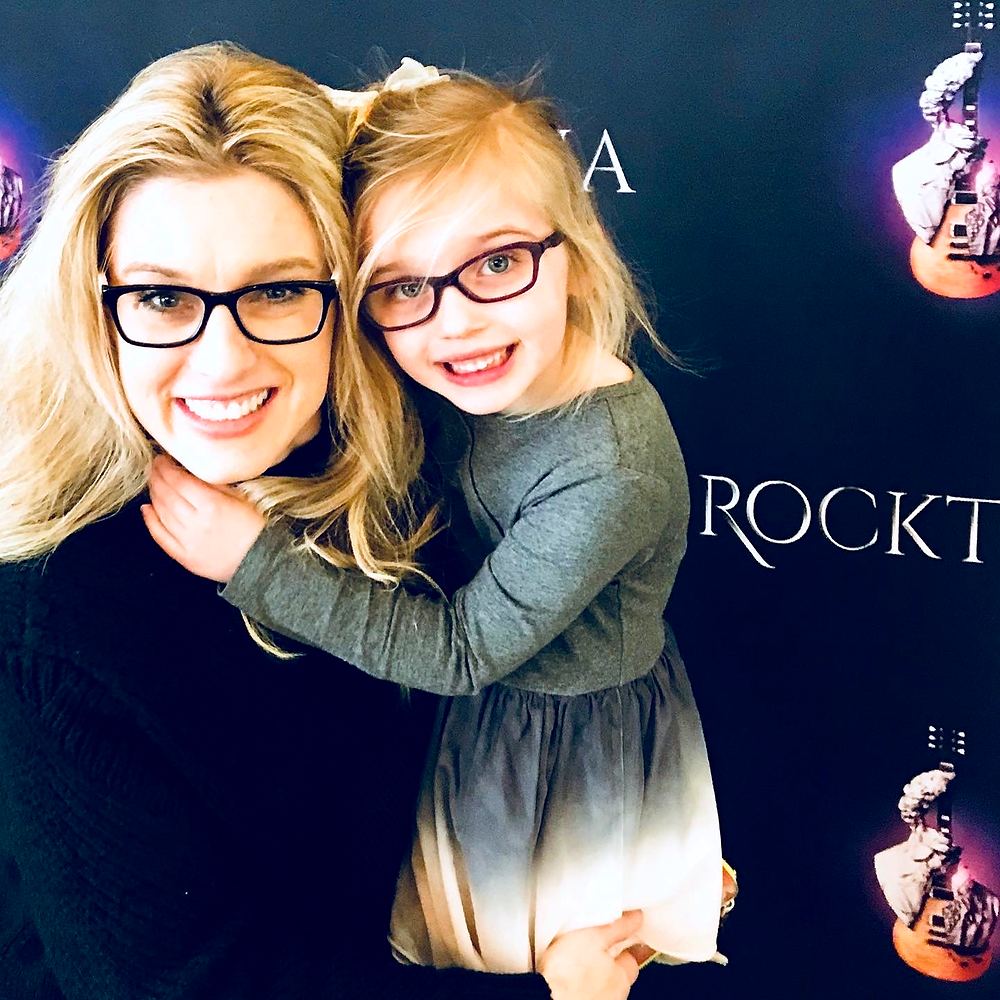 Cynthia Nordstrom with a young girl in front of a Rocktopia backdrop
