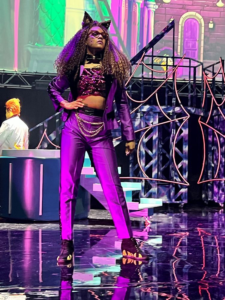 Clawdeen with wolf ears in a purple top, chains and metallic pants, Monster High Live. Costume design by Cynthia Nordstrom