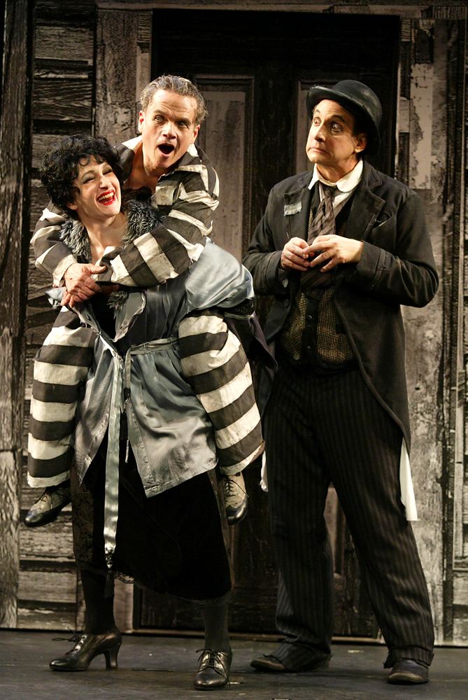 Actress in a striped coat held by an actor, beside a man in a bowler hat, Silent Laughter. Costume design by Cynthia Nordstrom
