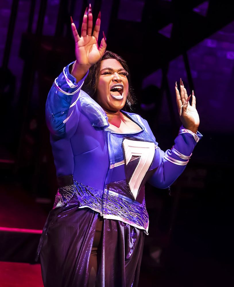 SuperYou at Curve, Leicester: a hero in a purple jacket with the number 7. Costume design by Cynthia Nordstrom