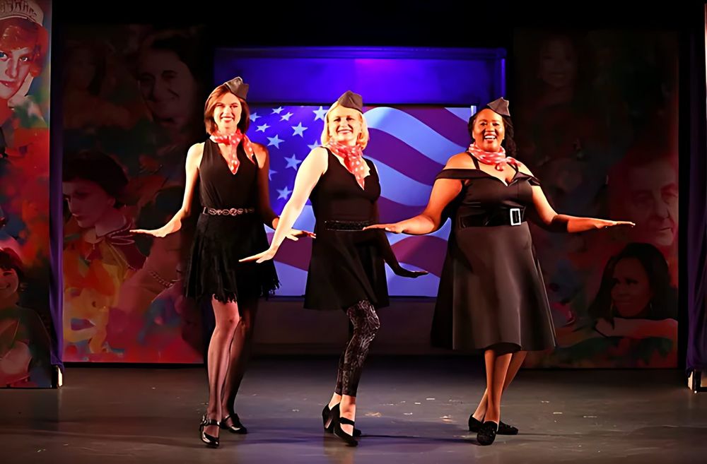 Three women in black dresses and silver jewelry dancing on stage, This One's for the Girls. Costume design by Cynthia Nordstrom