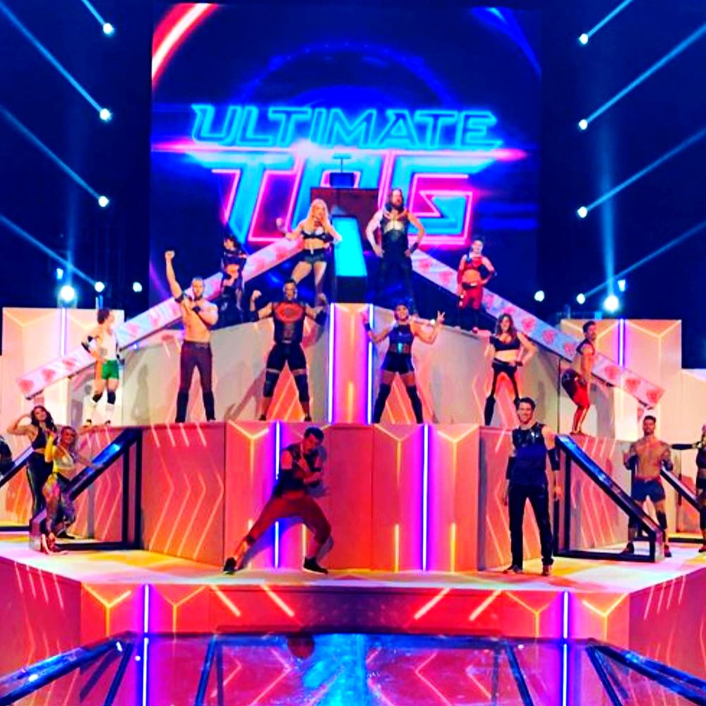 Cast of taggers posing across the neon Ultimate Tag arena set, Ultimate Tag (FOX). Costume design by Cynthia Nordstrom