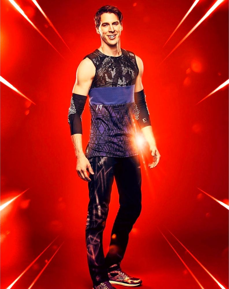 Tagger in a purple patterned tank and black printed pants, Ultimate Tag (FOX). Costume design by Cynthia Nordstrom