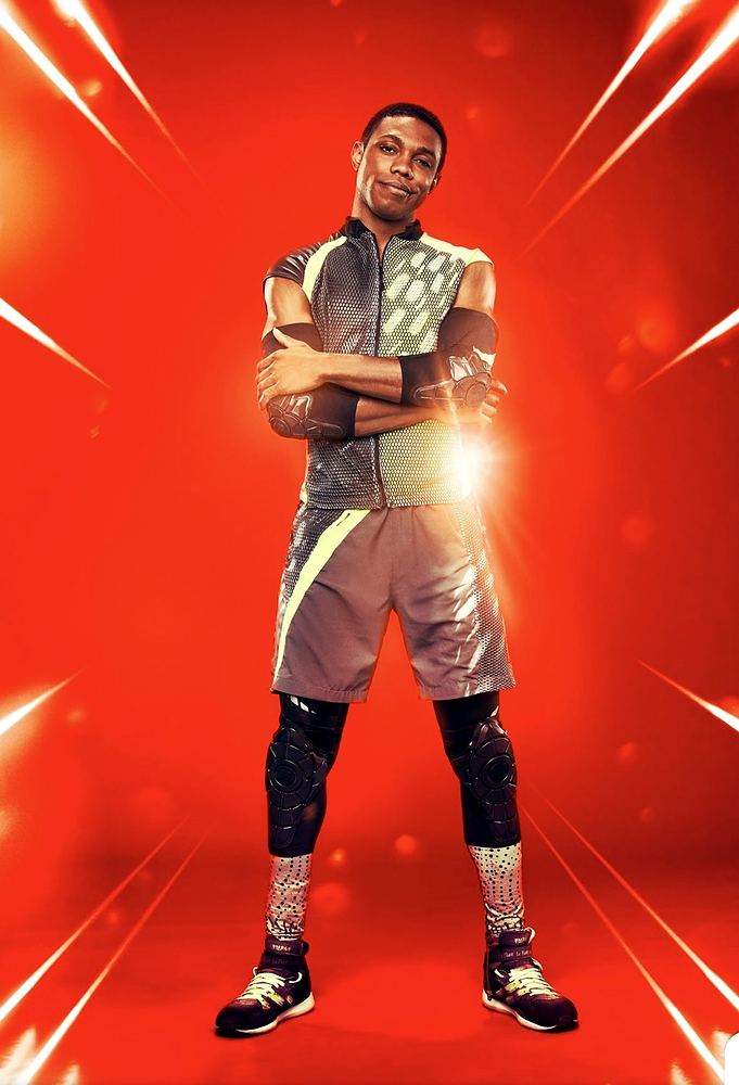 Tagger in a gray sleeveless top, shorts and kneepads with arms crossed, Ultimate Tag (FOX). Costume design by Cynthia Nordstrom