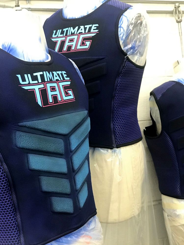 Navy Ultimate Tag vests with ribbed panels on dress forms, Ultimate Tag (FOX). Costume design by Cynthia Nordstrom
