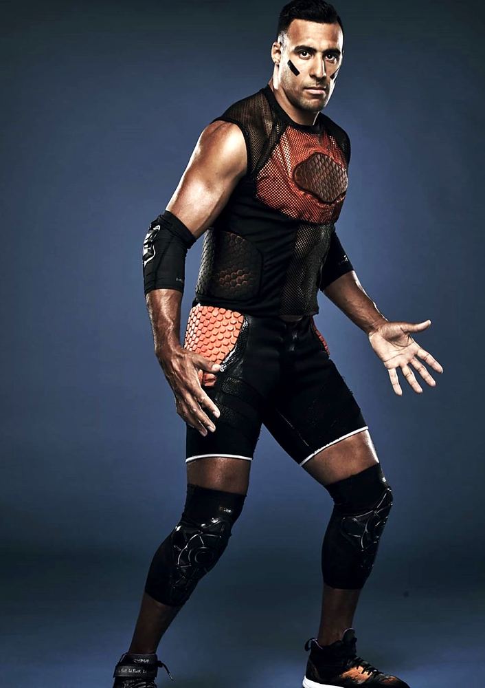 Tagger in a black mesh top with a red chest panel and kneepads, Ultimate Tag (FOX). Costume design by Cynthia Nordstrom