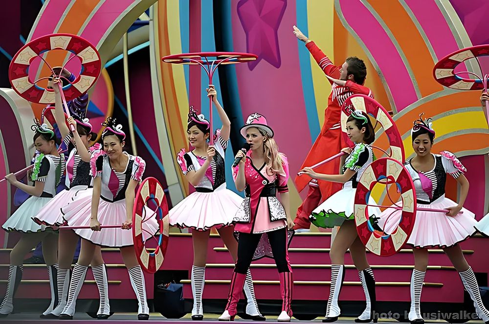 Dancers in pink and white ruffled candy costumes with lollipop props, USJ anniversary shows. Costume design by Cynthia Nordstrom