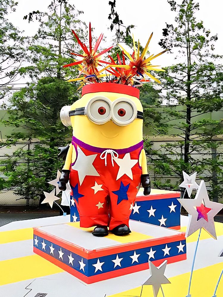 Minion in a red stars-and-stripes suit and spiky hat on a parade float, USJ anniversary shows. Costume design by Cynthia Nordstrom