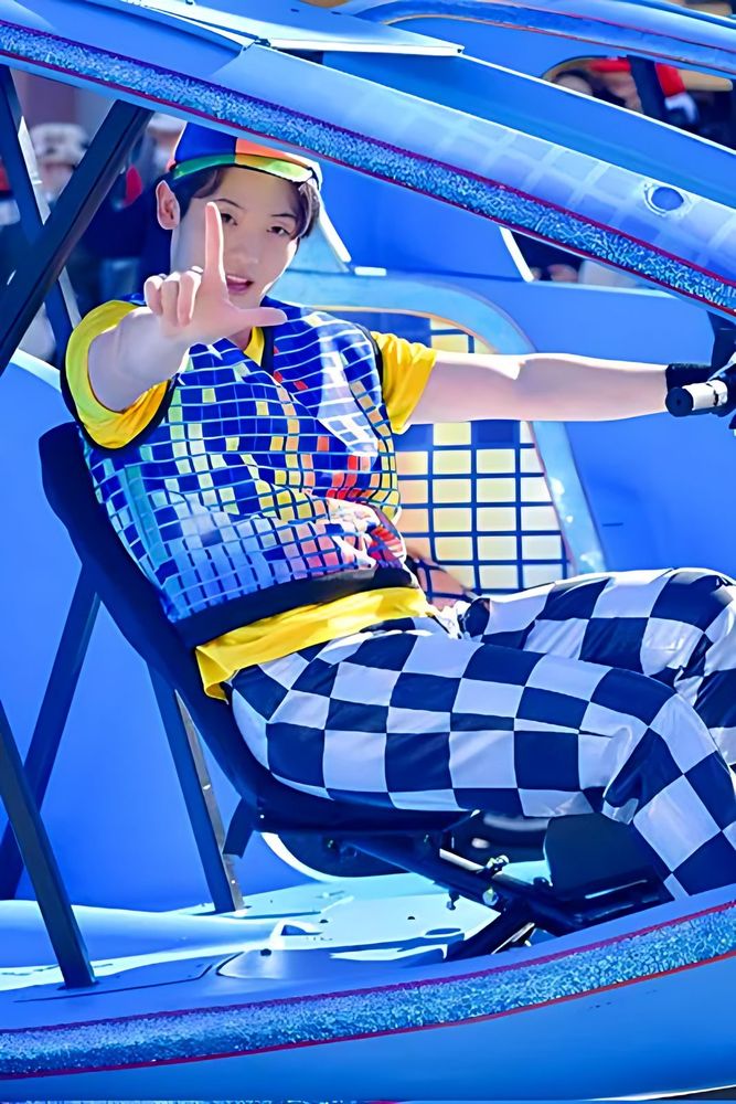 Dancer in a checkered race-inspired jacket and pants seated on a float, NO LIMIT! Parade, USJ. Costume design by Cynthia Nordstrom