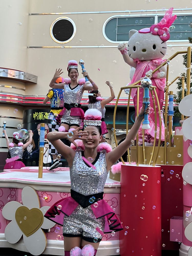 Dancer in a silver sequin top and pink skirt on the Hello Kitty float, NO LIMIT! Parade, USJ. Costume design by Cynthia Nordstrom