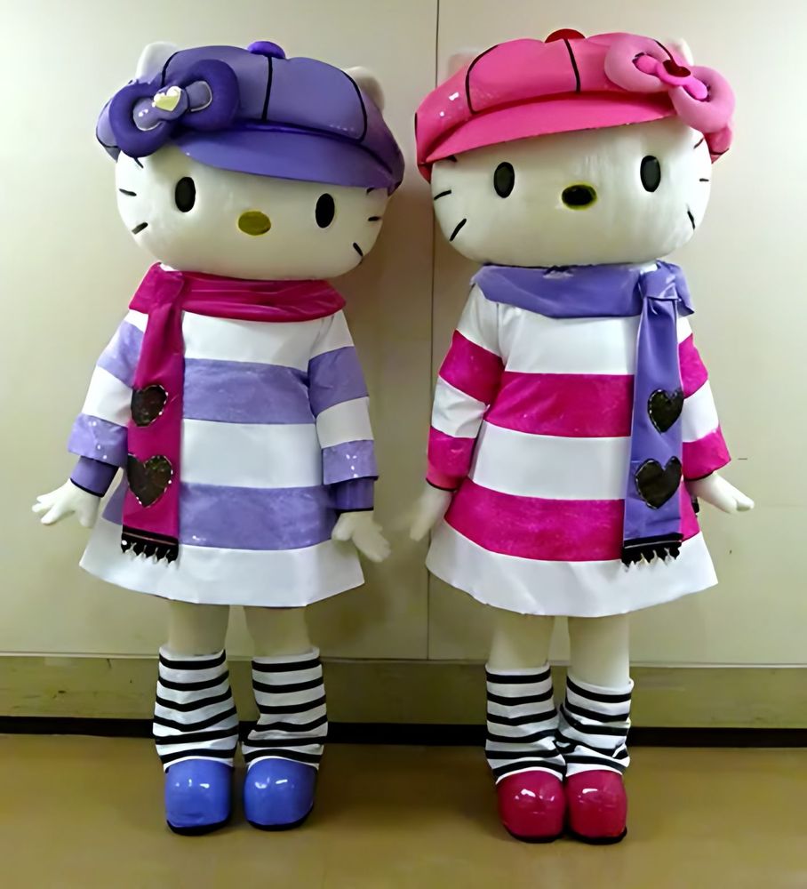 Two Hello Kitty characters in winter caps, striped scarves and sweater dresses, USJ anniversary shows. Costume design by Cynthia Nordstrom