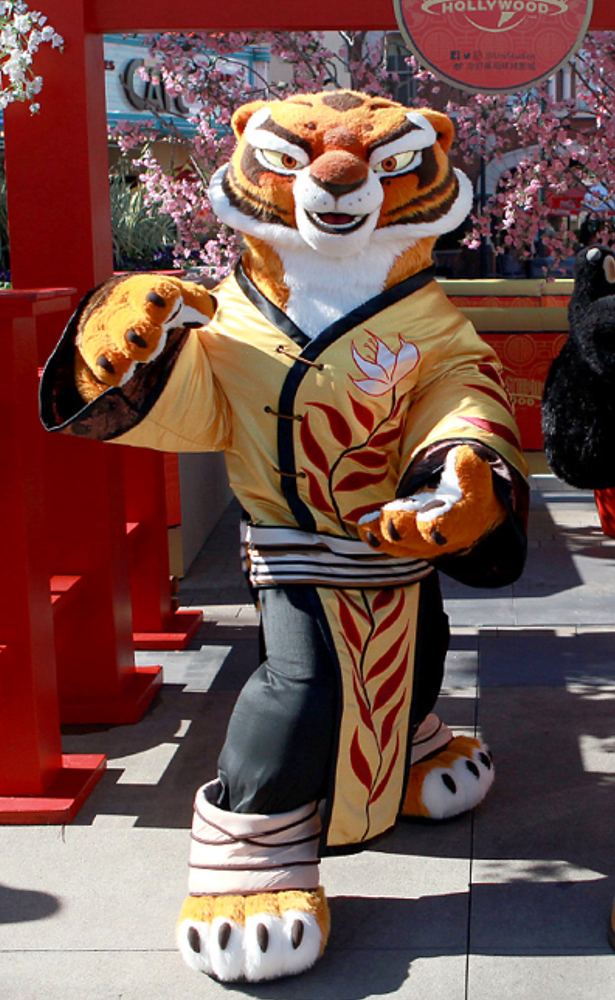 Tigress in a gold and black embroidered tunic greeting guests, Kung Fu Panda Land of Awesomeness, Universal Beijing Resort. Costume design by Cynthia Nordstrom